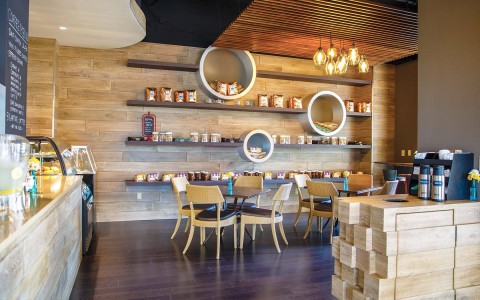 cafe with chairs and shelves with food