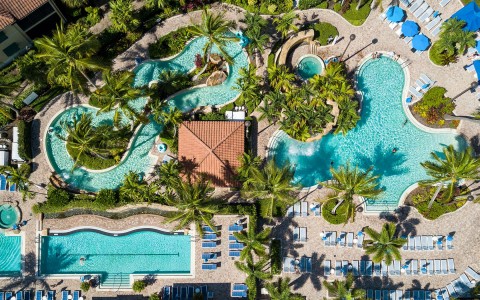 aerial view of the different hotel pools and the sun beds