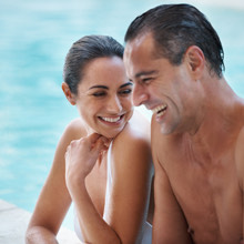 man and woman laughing inside pool