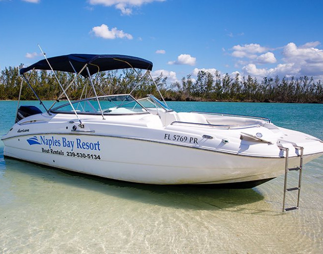 a rental boat anchored on a sandbar in the water