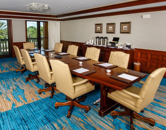 boardroom meeting table room with light brown leather swivel chairs