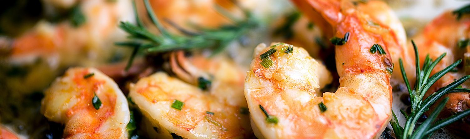 plate of shrimp garnished with herbs