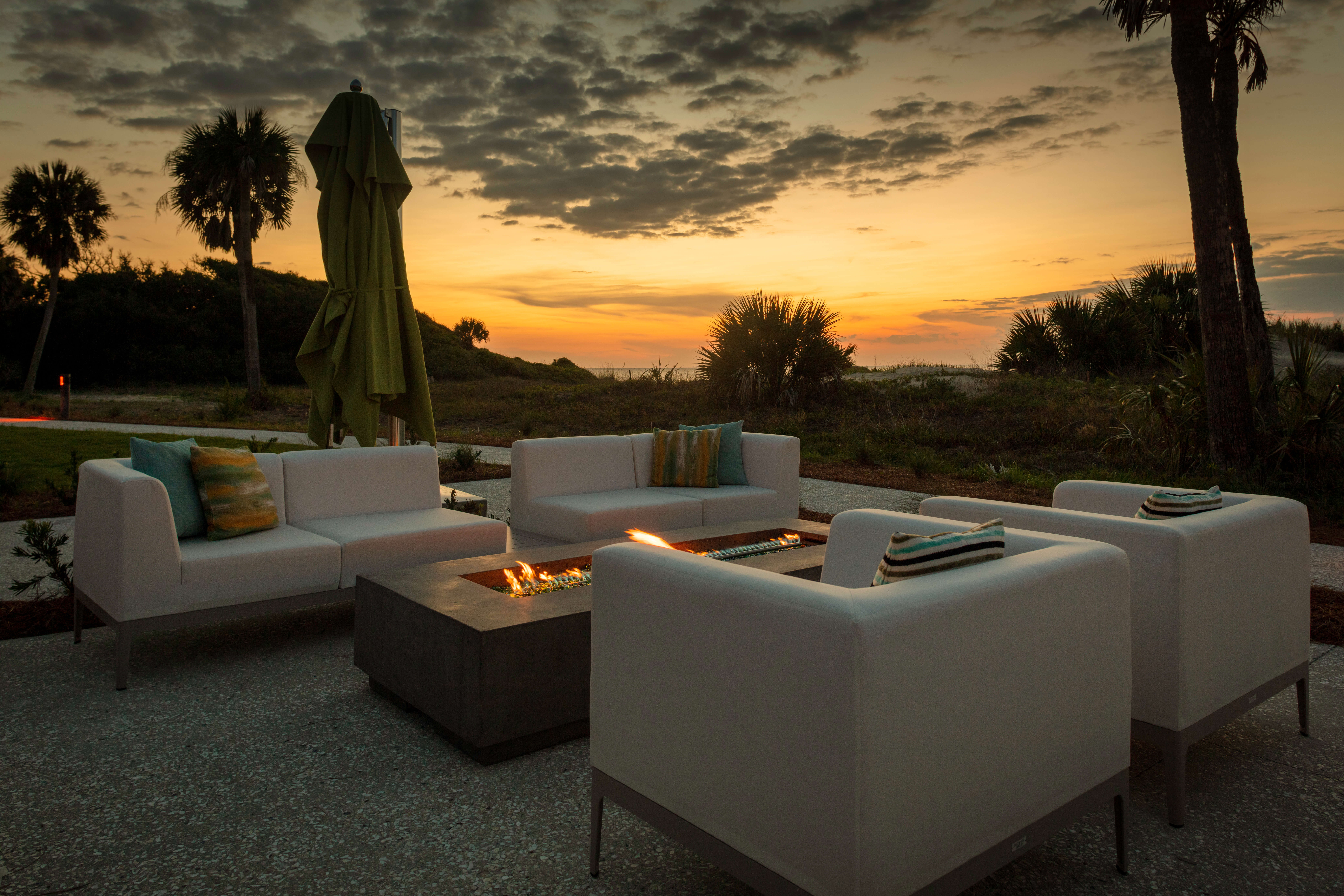 view of white outdoor sofas during sunset