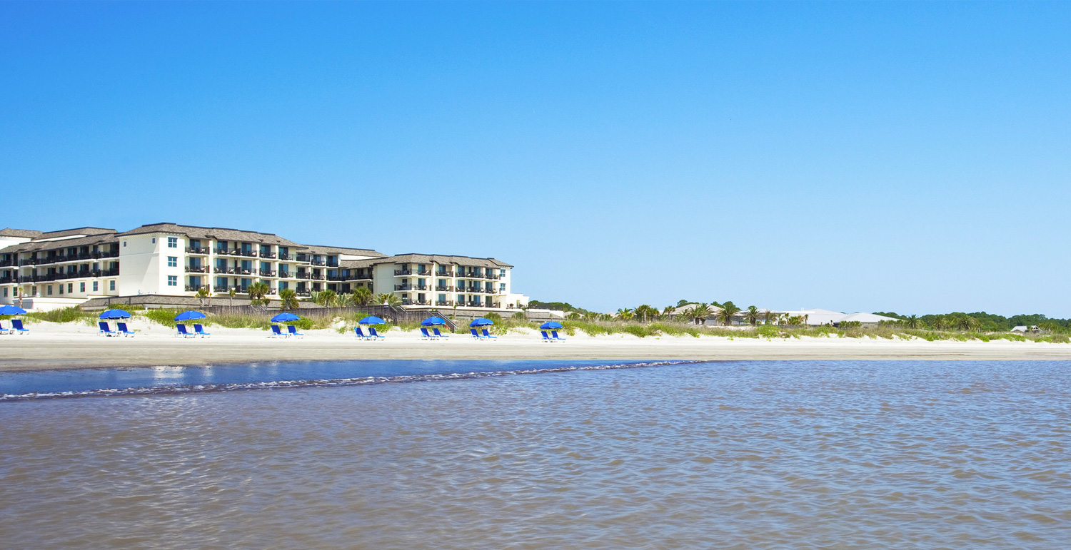 Ocean with sand and hotel in the background