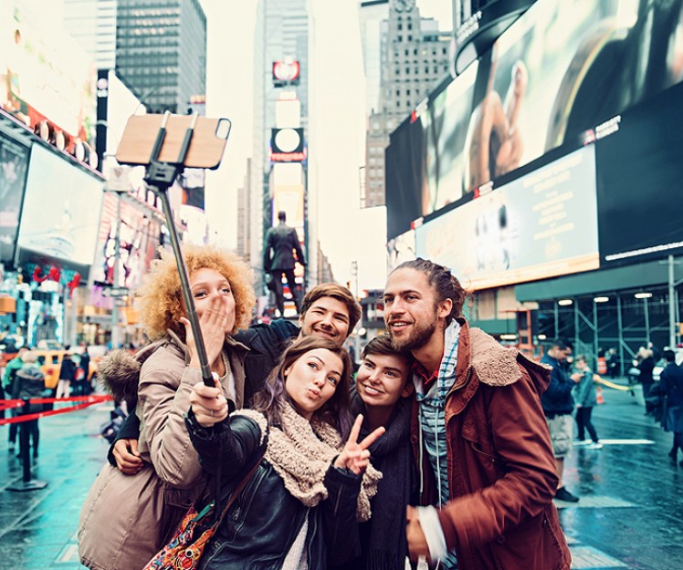 friends taking selfie at times square
