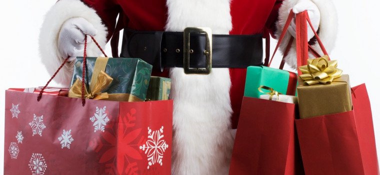Shopper in Santa Claus Costume Holds Many Gift Wrapped Packages in Holiday Bags