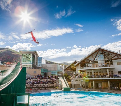 man skiing off a ramp in Utah Olympic Park