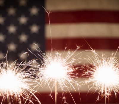sparklers with the American flag in the back