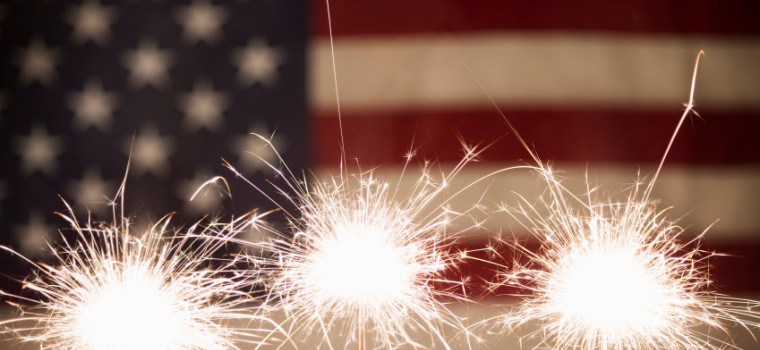 sparklers with the American flag in the back