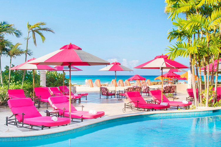 red chairs with umbrellas by the beach