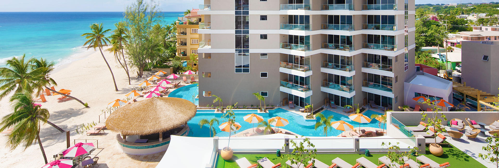 wide view of the hotel, pool, and beach