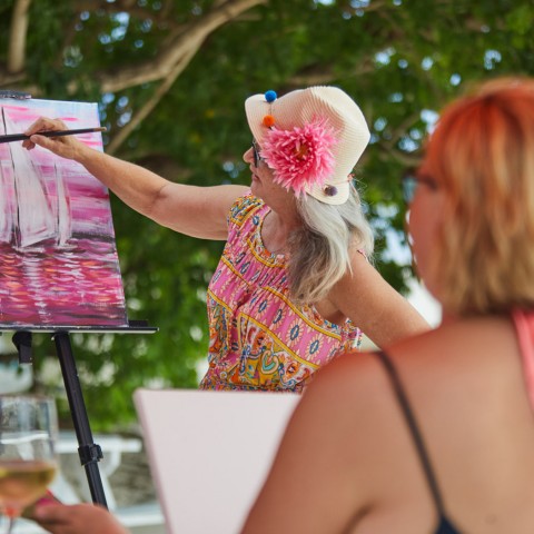 woman painting sailboat image