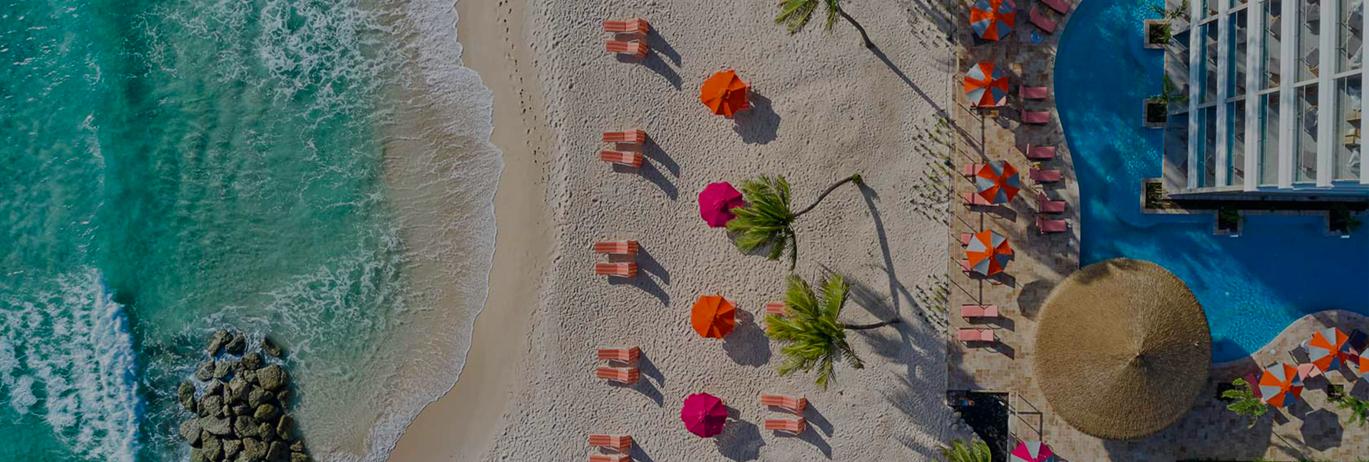 aerial shot of beachfront pool and lounge chairs