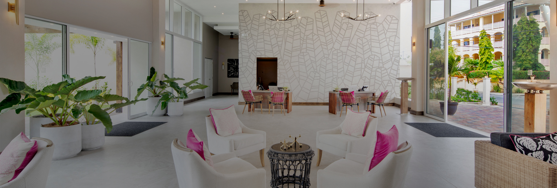 lobby area with seating areas and pink pillows