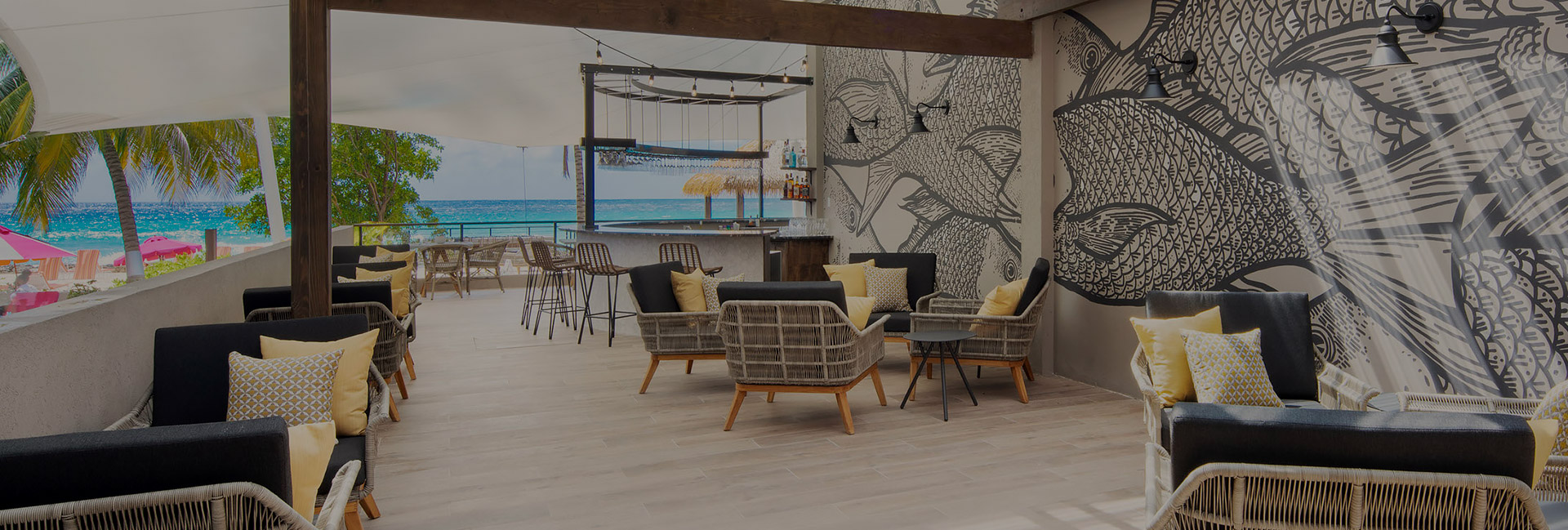 outdoor patio next to the beach with black and yellow furniture