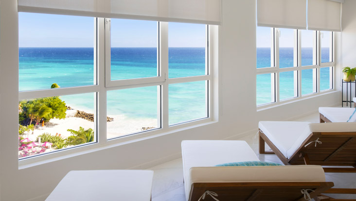 4 lounge chairs inside spa overlooking ocean