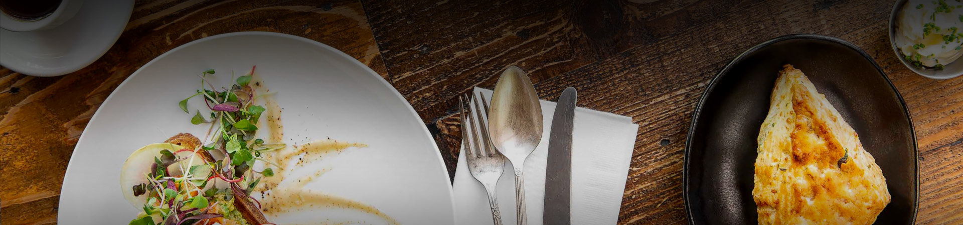 a wooden table with various plates of food