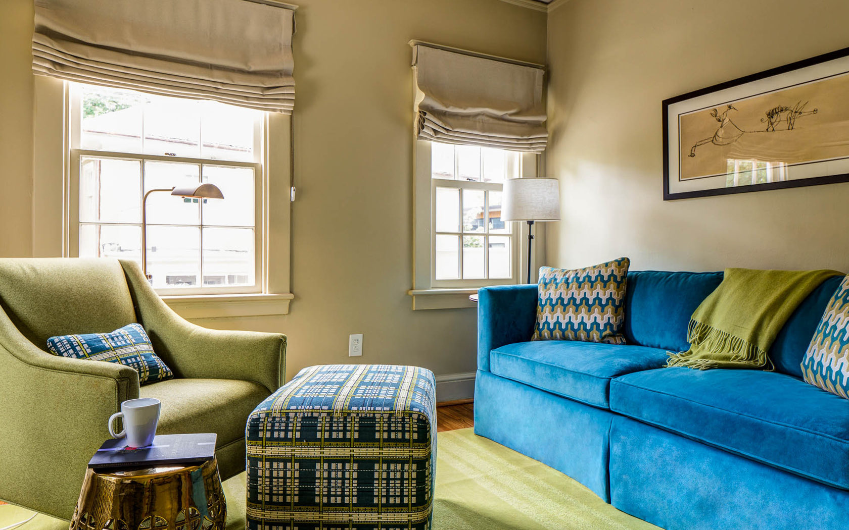 room with blue couch and a green chair 