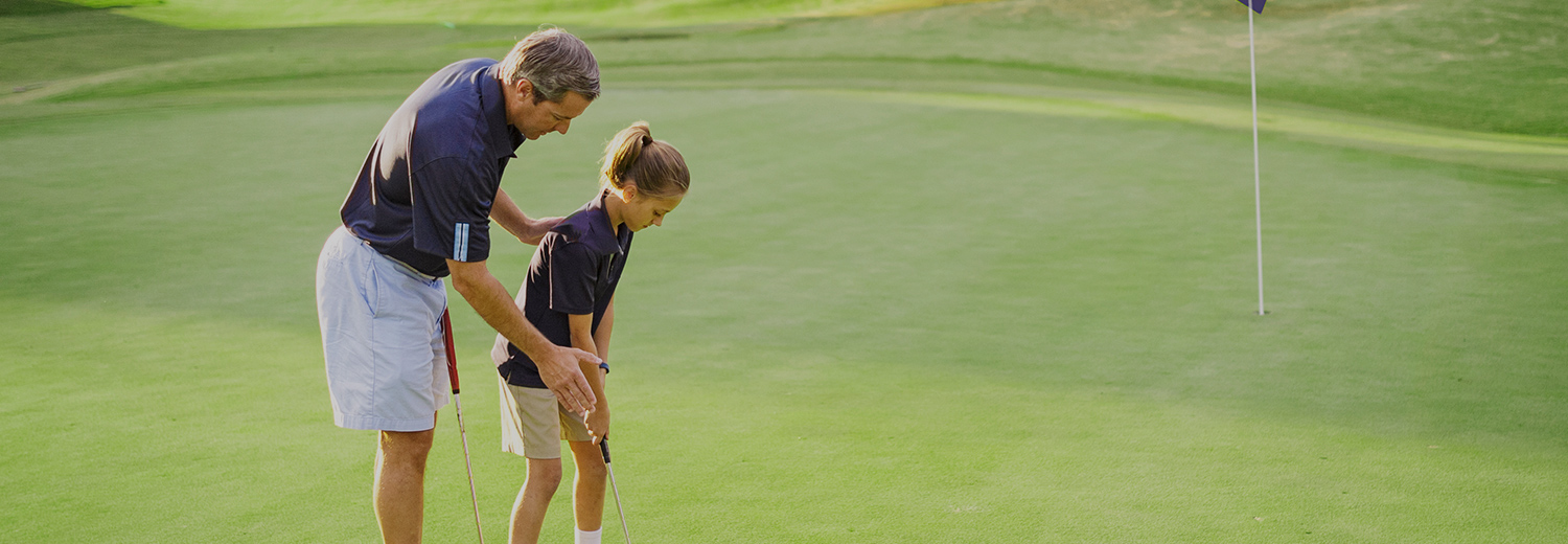 a young girl learning to play golf