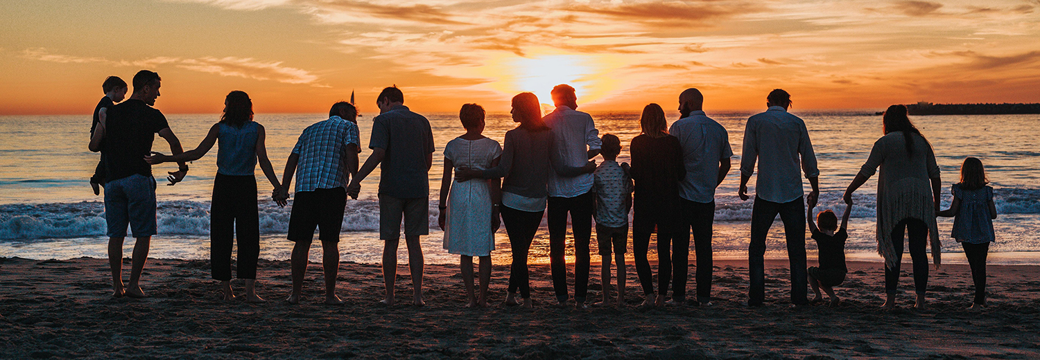 family overlooking the beach sunset