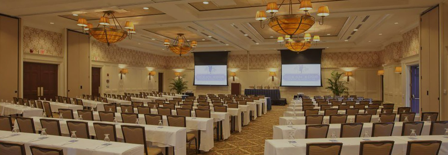 event space set up with long tables and chairs for a conference meeting
