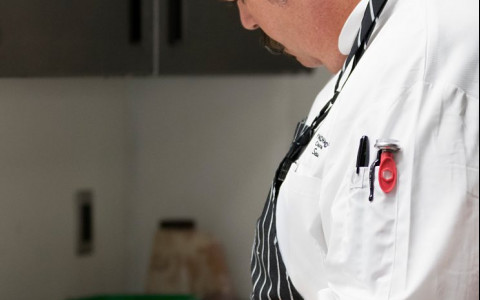 Chef following recipe in kitchen 