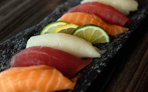 Row of raw fish with slices of lime