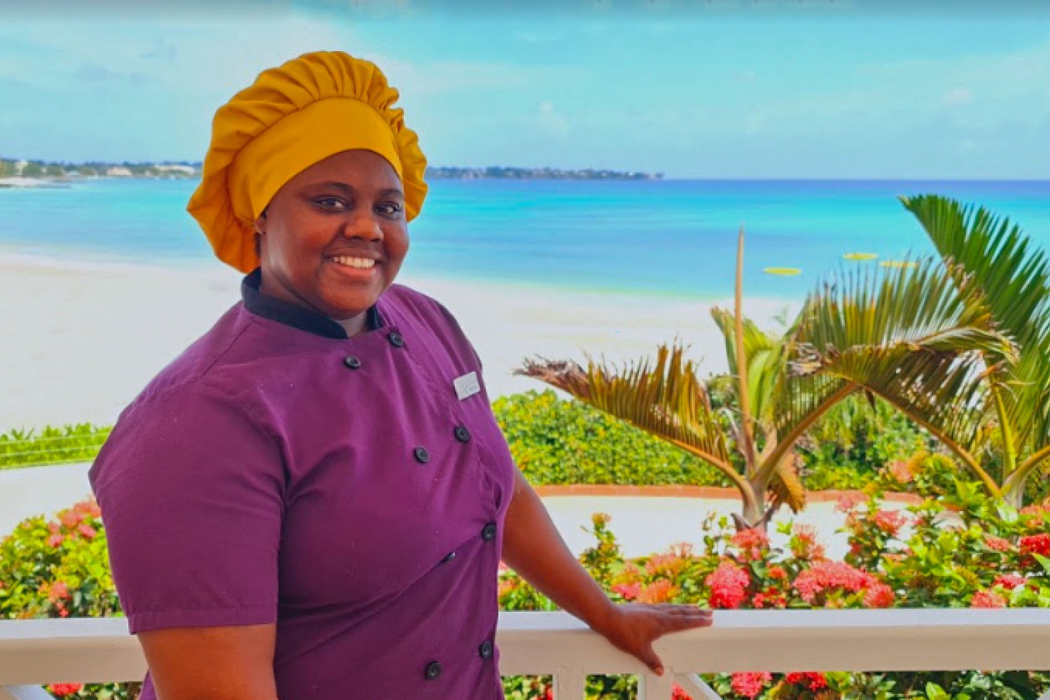 chef with purple uniform with the ocean behind