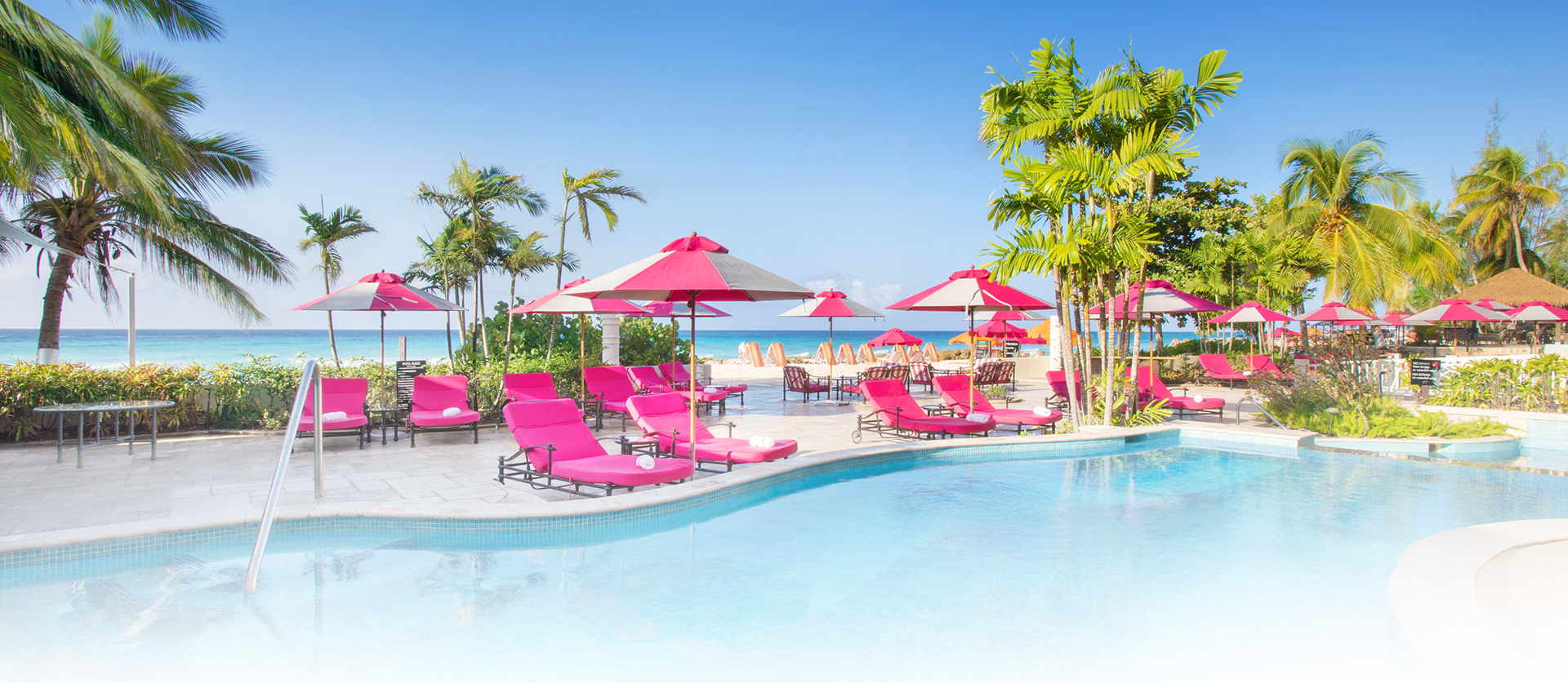 pink lounge chairs next to pool