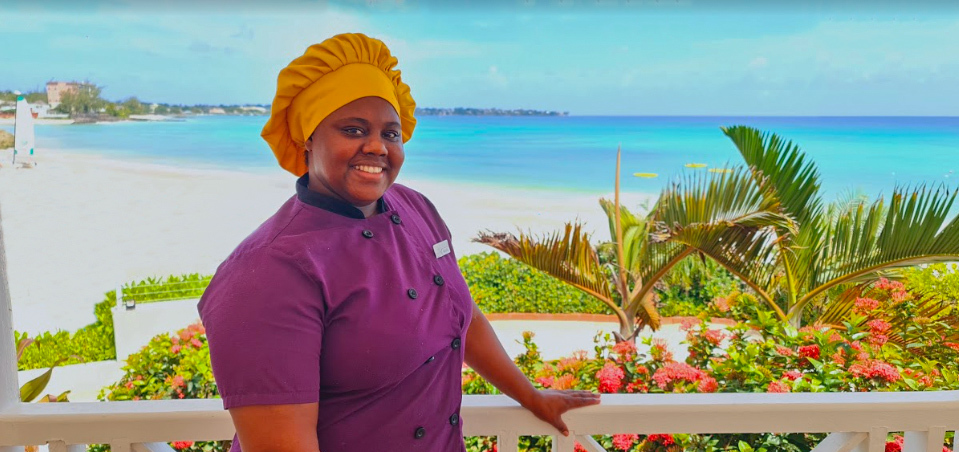 chef with purple uniform with the ocean behind