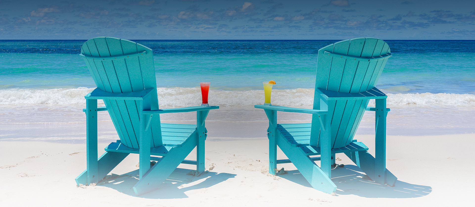 blue chairs next to ocean