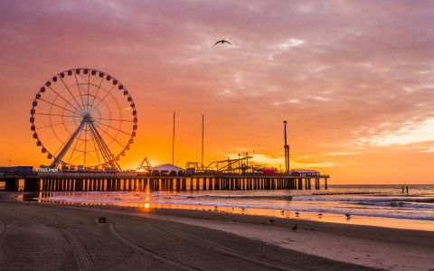 pier at sunset with ferris wheel