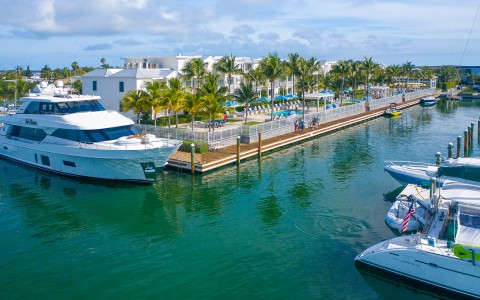 white yacht docked in the water next to the hotel