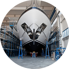 Front view of a big sailboat on a mechanic workshop