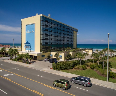 Aerial view of cars driving by hotel property building
