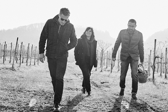 Three people walking in the nature in black and white colors