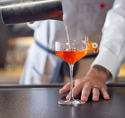 closeup view of a bartender making a fancy female cocktail 