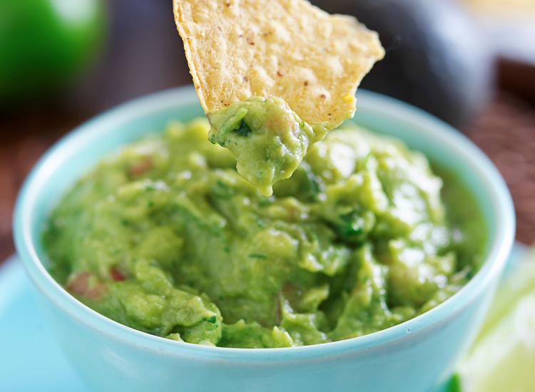 close up view of guacamole and nachos