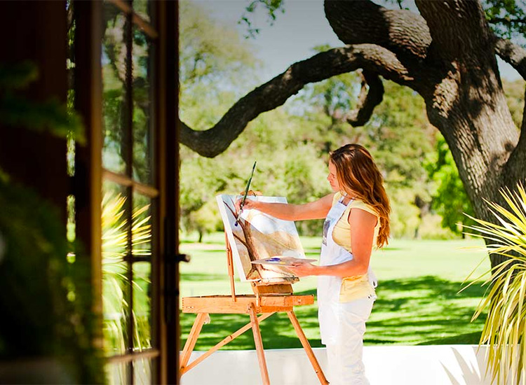 woman painting her view at daytime