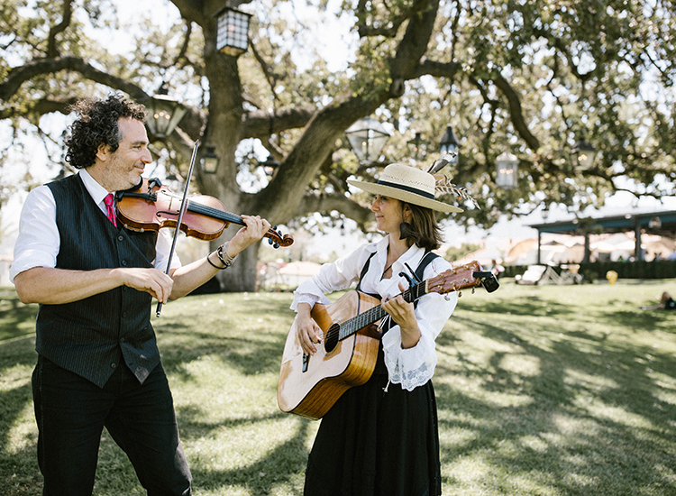 man and woman playing violin and guitar