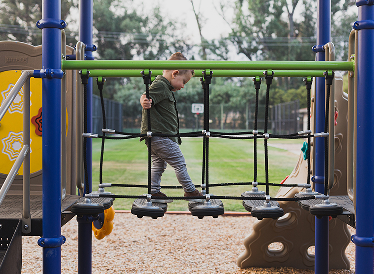 Little kid playing on a jungle gym