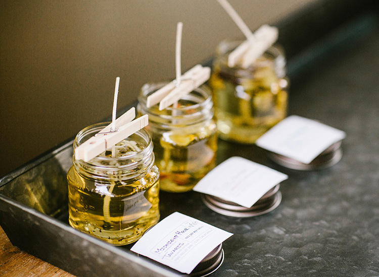three small bottles with oil and notes in front of them