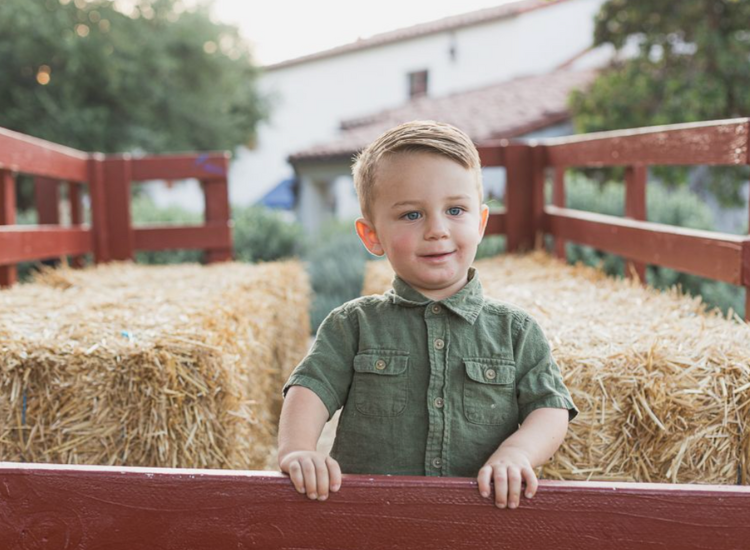 Toddler inside a hay wagon
