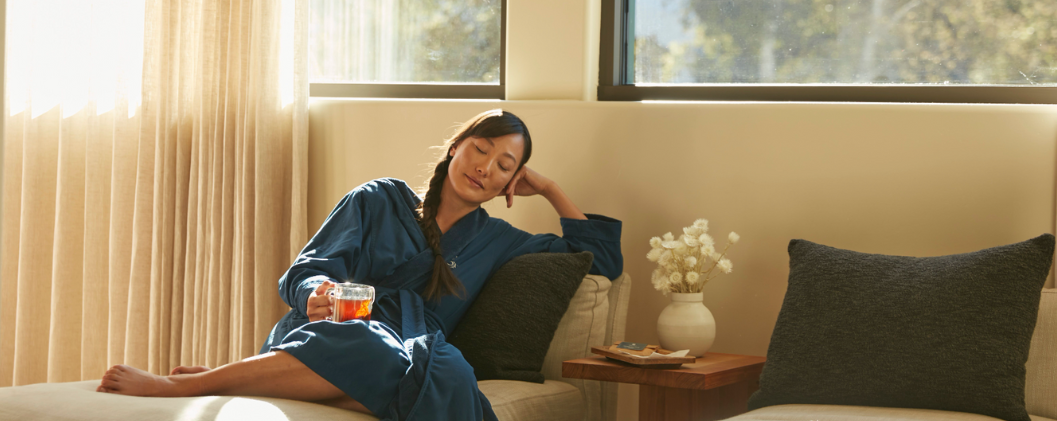Woman drinking tea and relaxing at the spa 