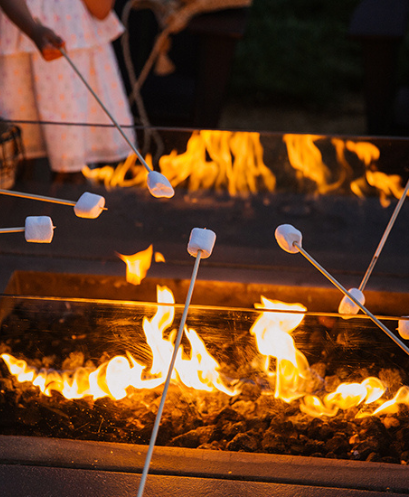 A group of people roasting marshmallow 