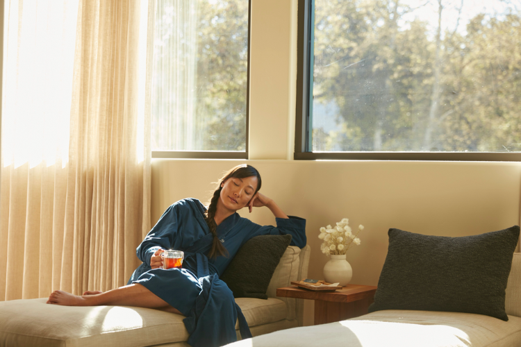 Woman relaxing and drinking a cup of tea at a spa