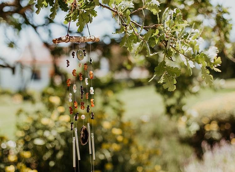 wind chimes with little beads hanging from a tree