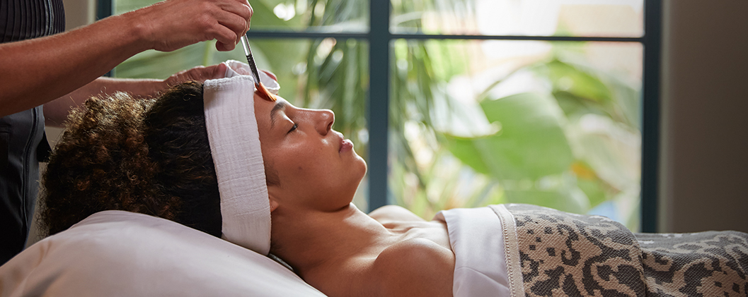 Woman in a spa bed getting a facial