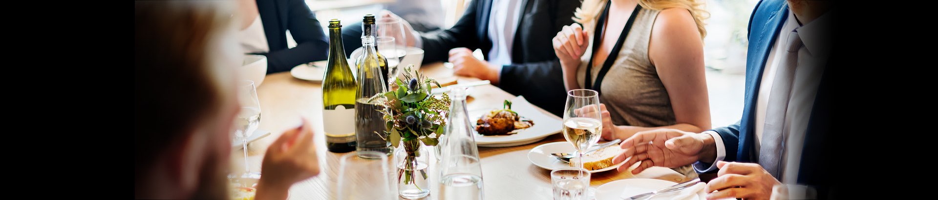 long table with people enjoying meal