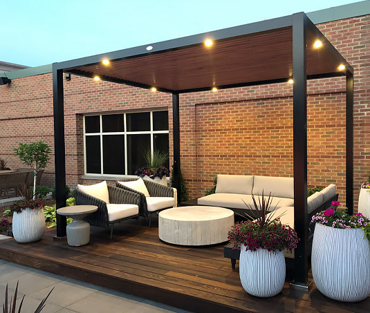 private pergola with plants, chairs and couches